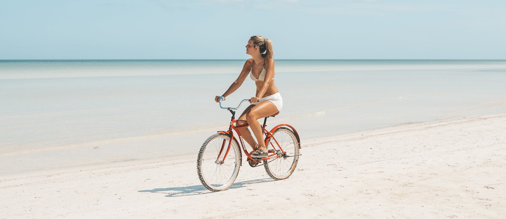 bicycle vehicle person wheel outdoors sea nature shoreline beach coast