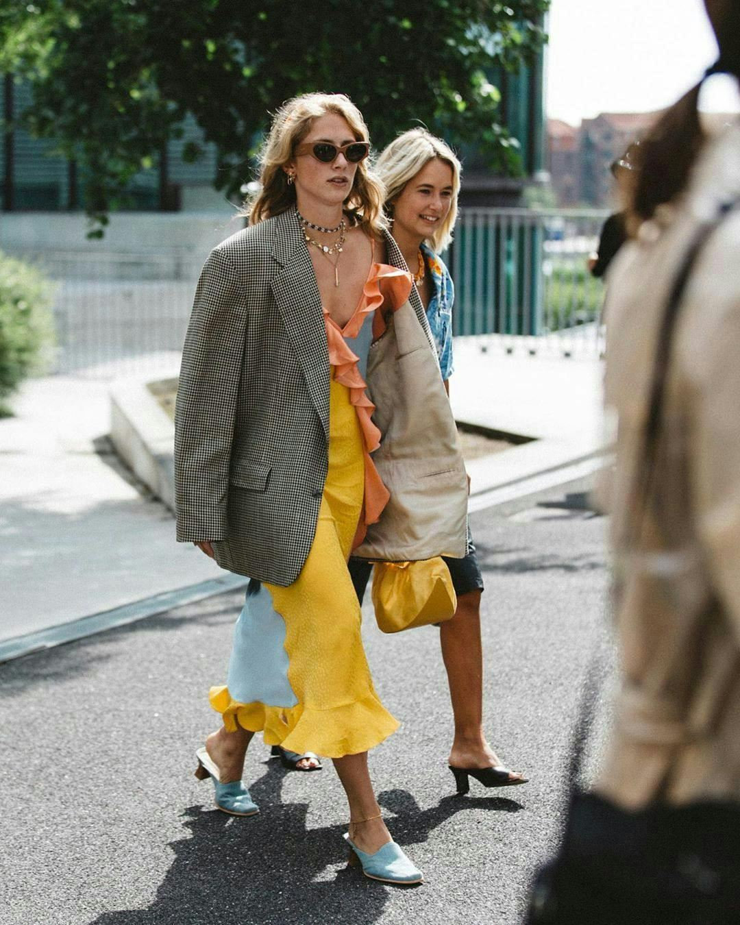 apparel clothing person sunglasses accessories road pedestrian shorts tarmac footwear