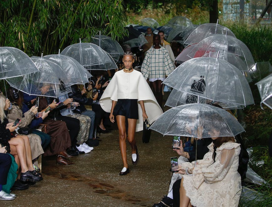apparel clothing human person shorts umbrella canopy footwear shoe helmet