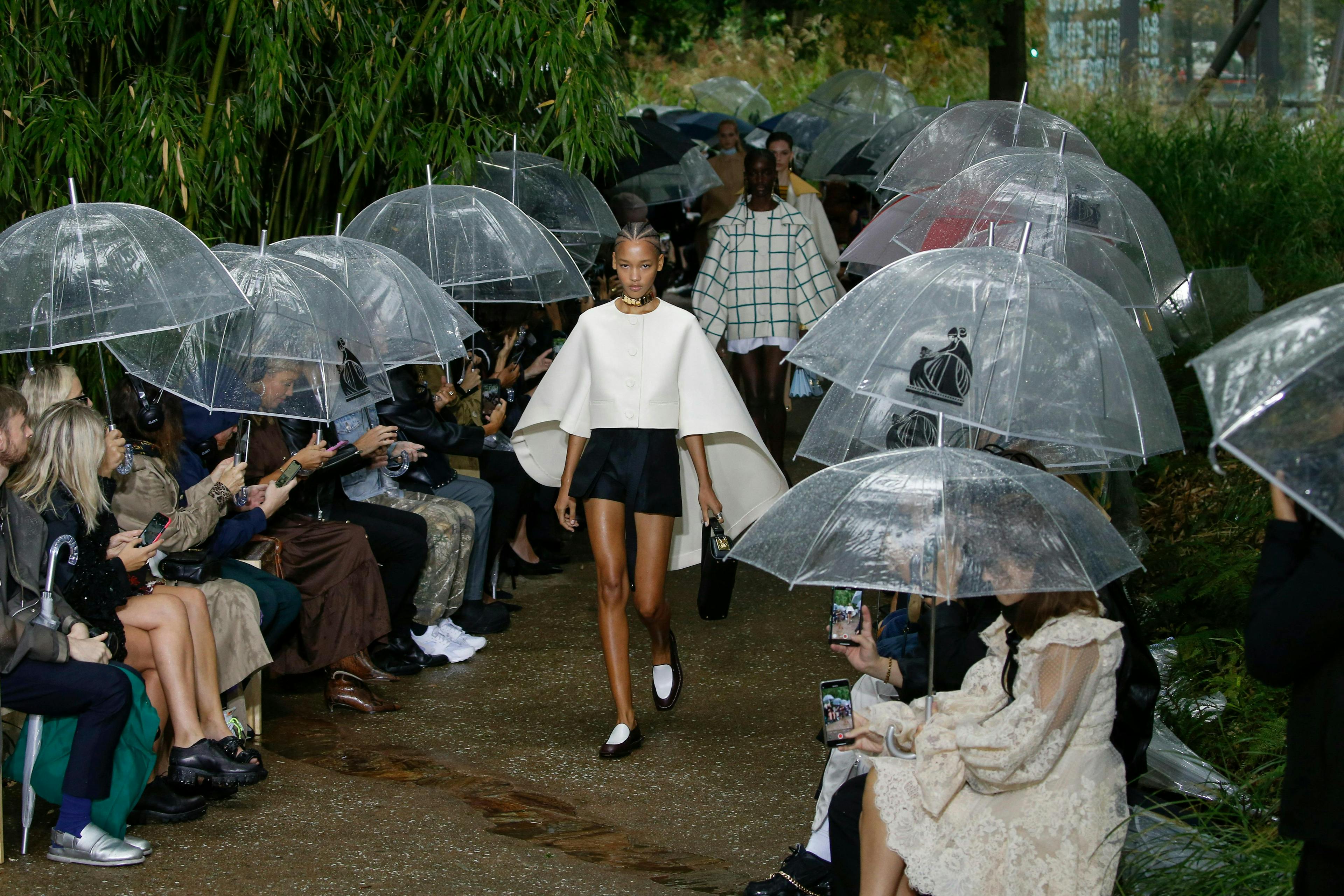 clothing apparel human person shorts umbrella canopy shoe footwear helmet