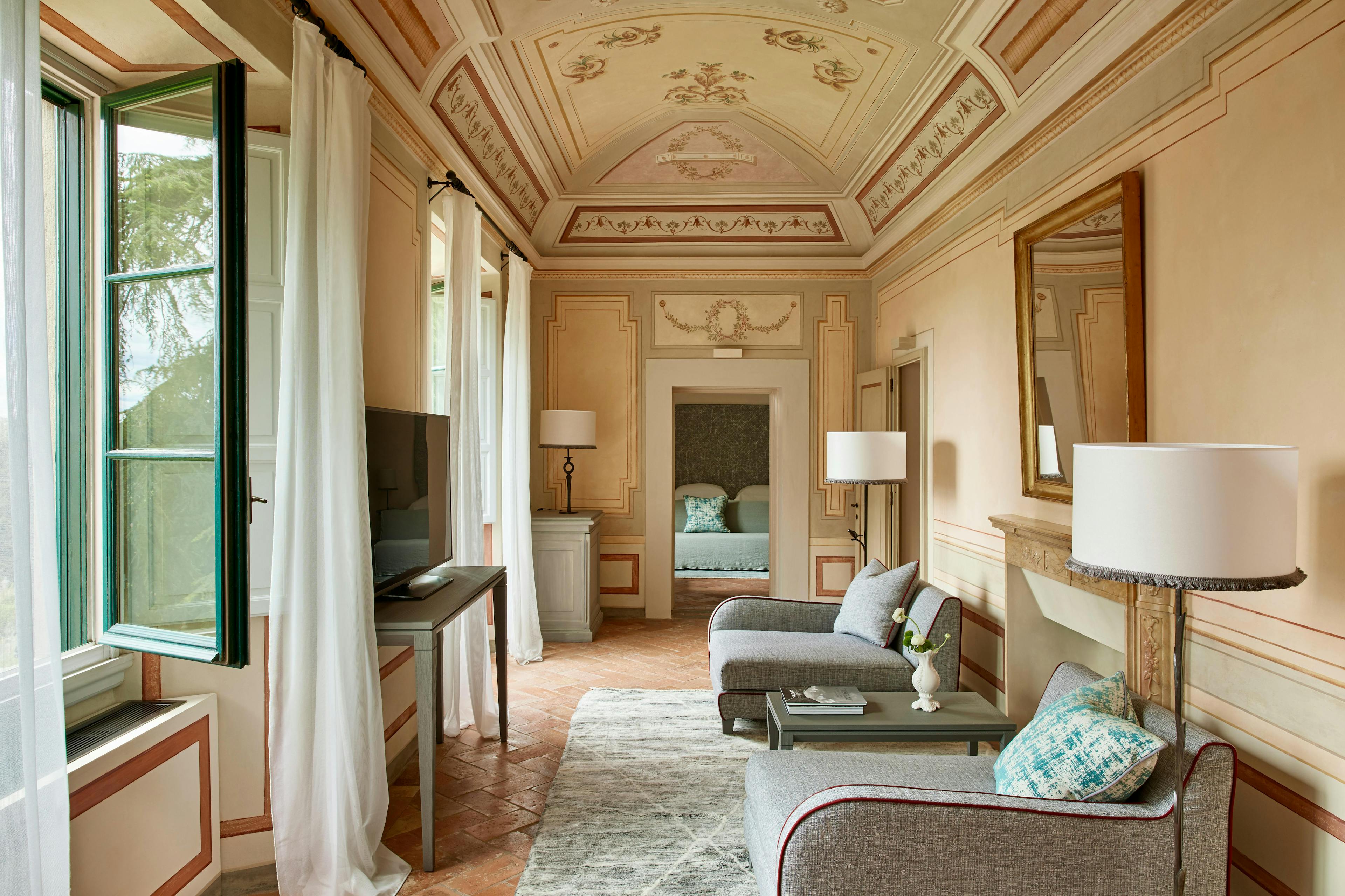 castello del nero como como hotels and resorts italy hotel europe tuscany sala gran camino flooring room indoors living room furniture floor couch