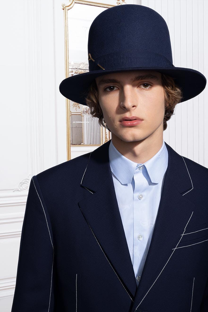 apparel clothing person human suit coat overcoat hat sun hat