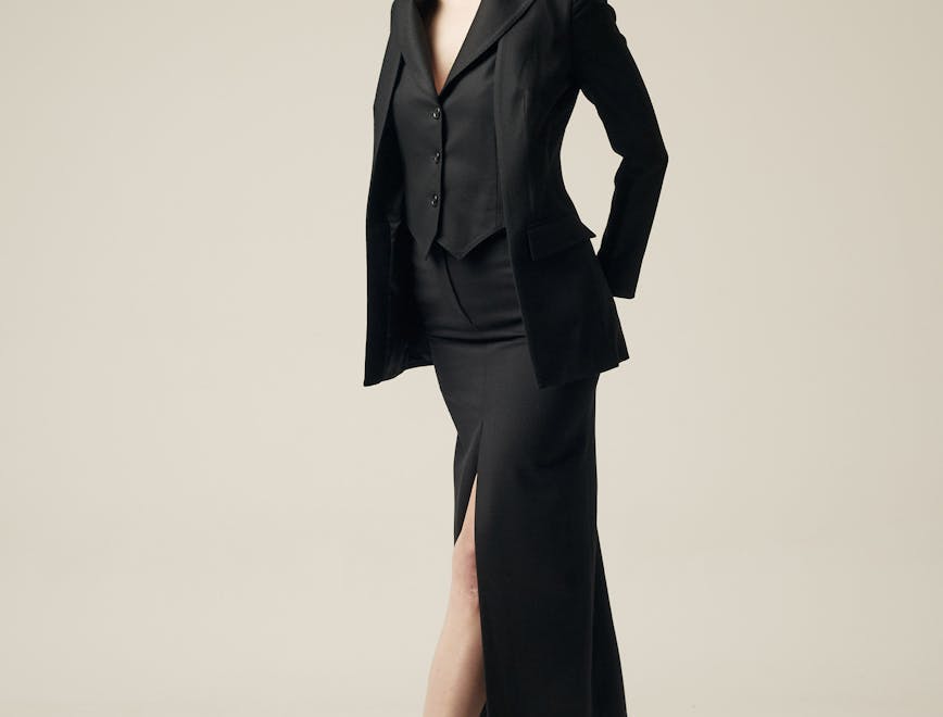 apparel clothing overcoat suit coat dress female person woman tuxedo