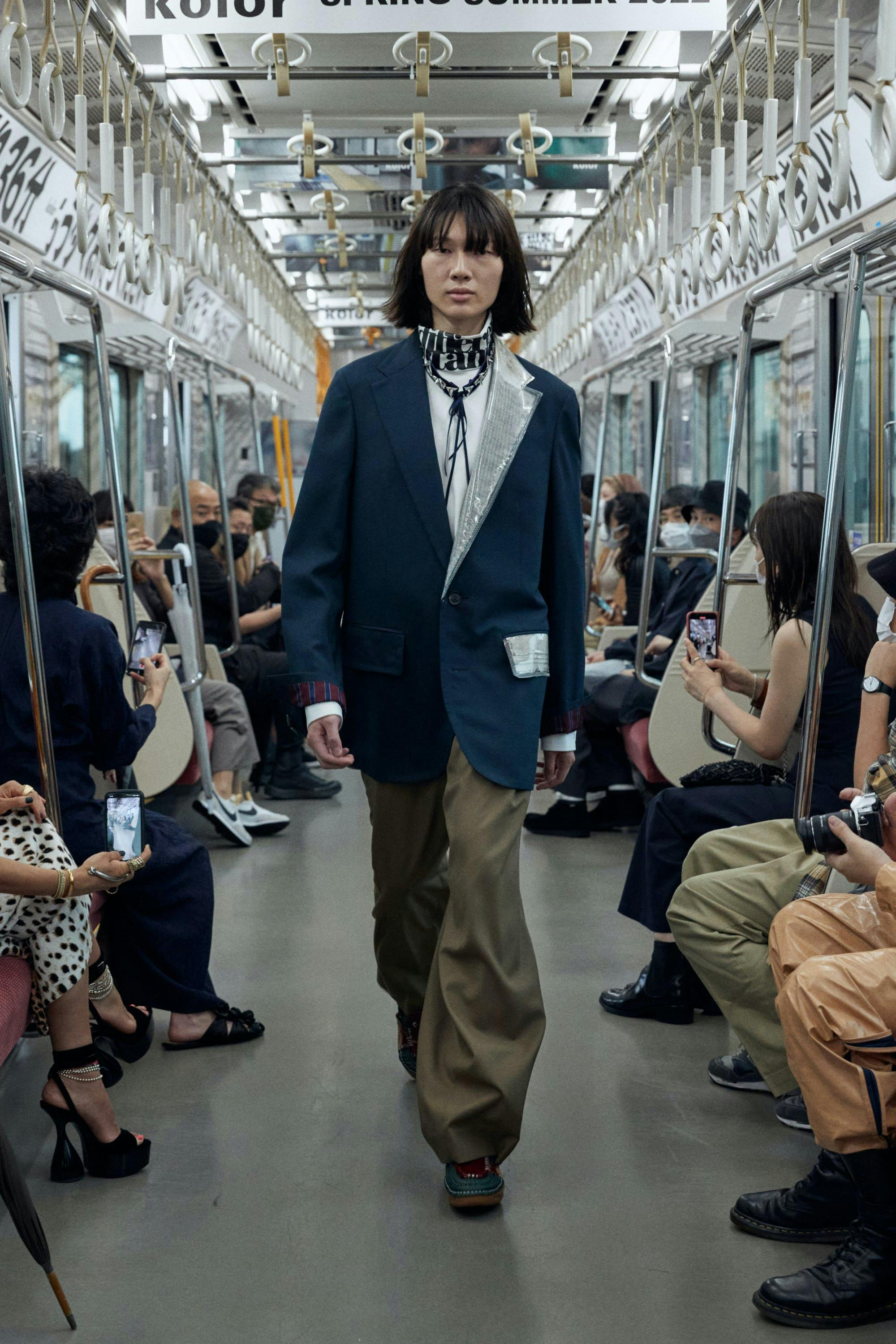clothing person shoe train station transportation terminal train suit overcoat coat
