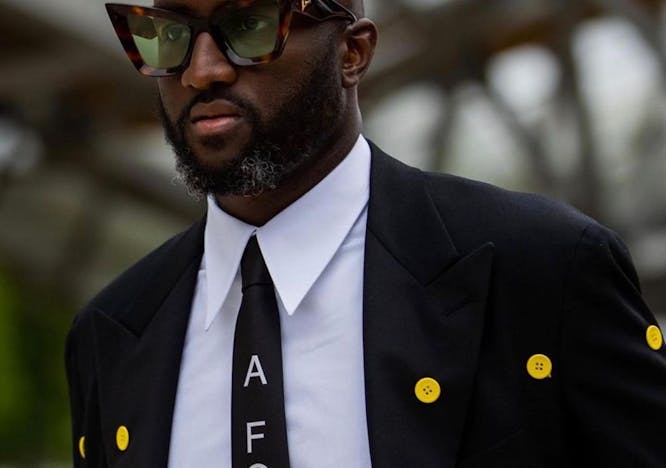 tie accessories suit coat overcoat clothing person sunglasses face necktie