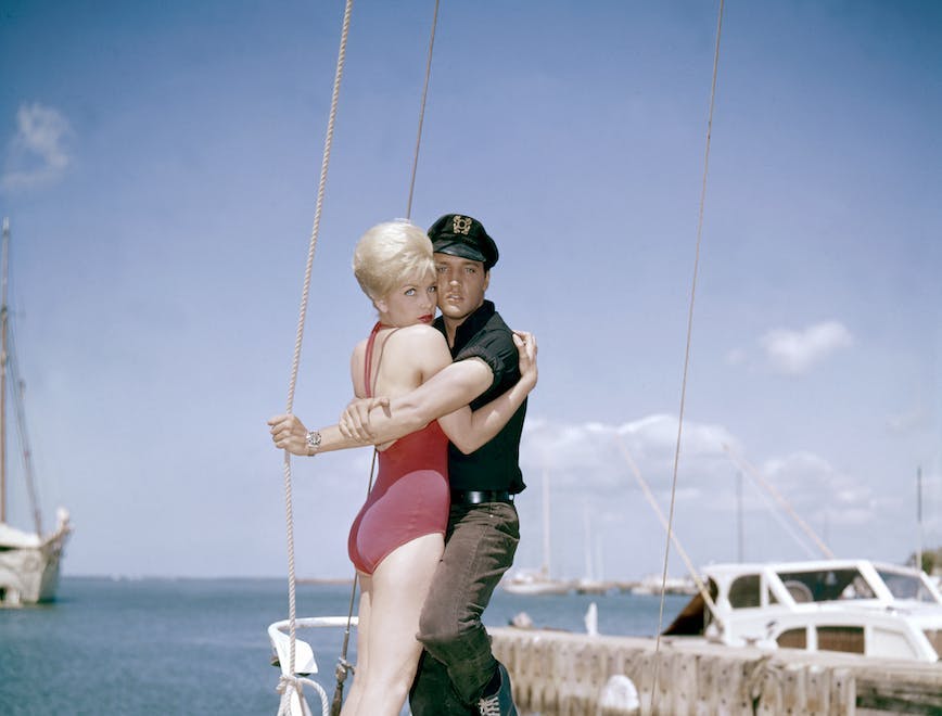 1960s two people young adult man young adult woman caucasian ethnicity movie set sailboat actress actor performing arts singer music celebrities hugging american movie film still hawaii elvis presley stella stevens person watercraft vehicle transportation water clothing waterfront pier wood boat
