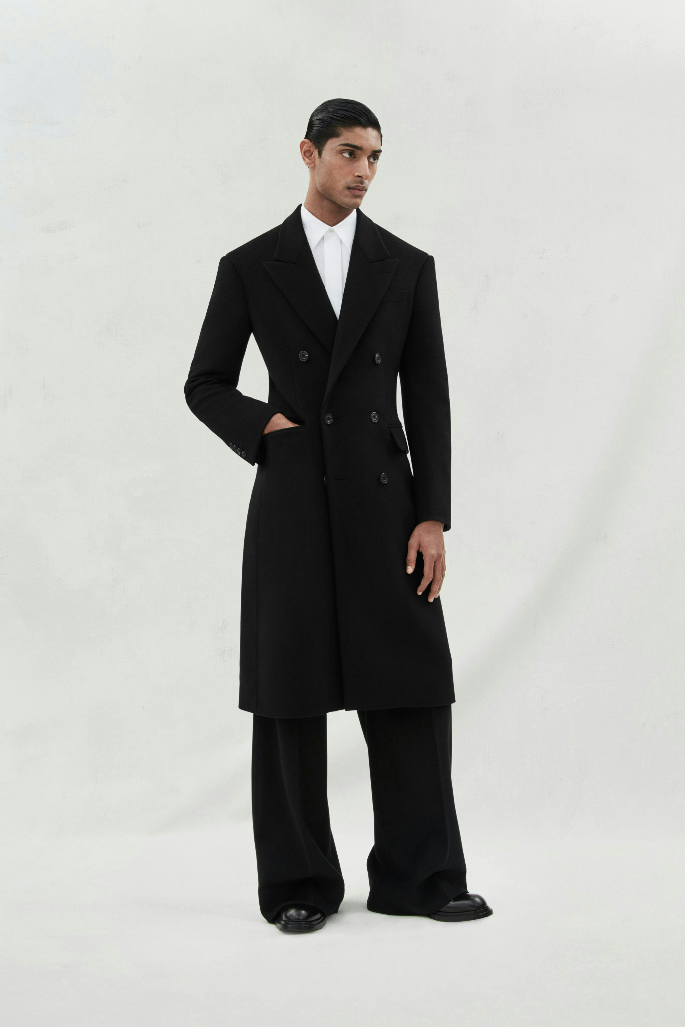 coat clothing overcoat person man adult male suit formal wear