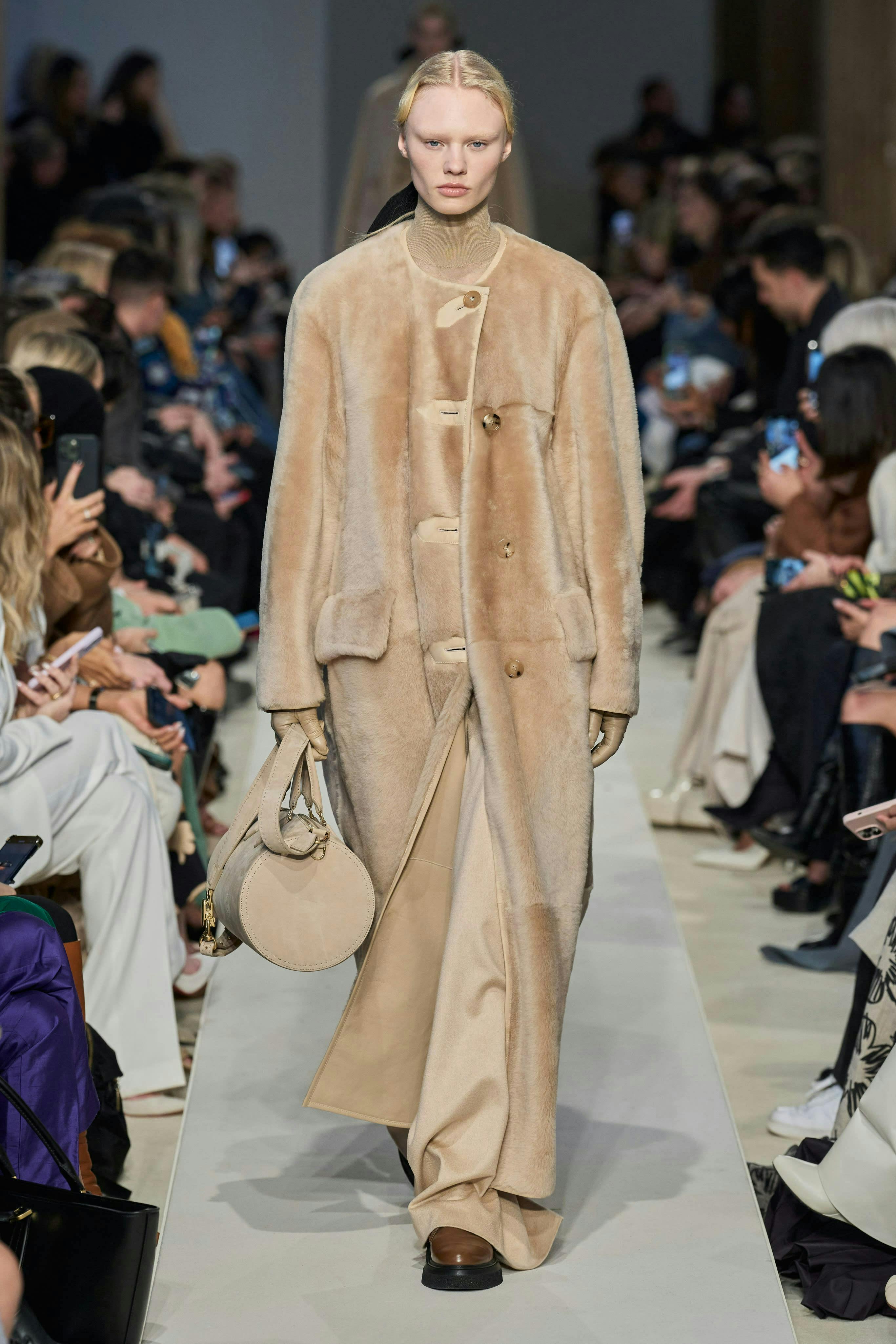 clothing coat fashion bag handbag lady person mobile phone phone overcoat