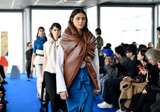 paris coat jacket fashion adult female person woman long sleeve mobile phone shoe