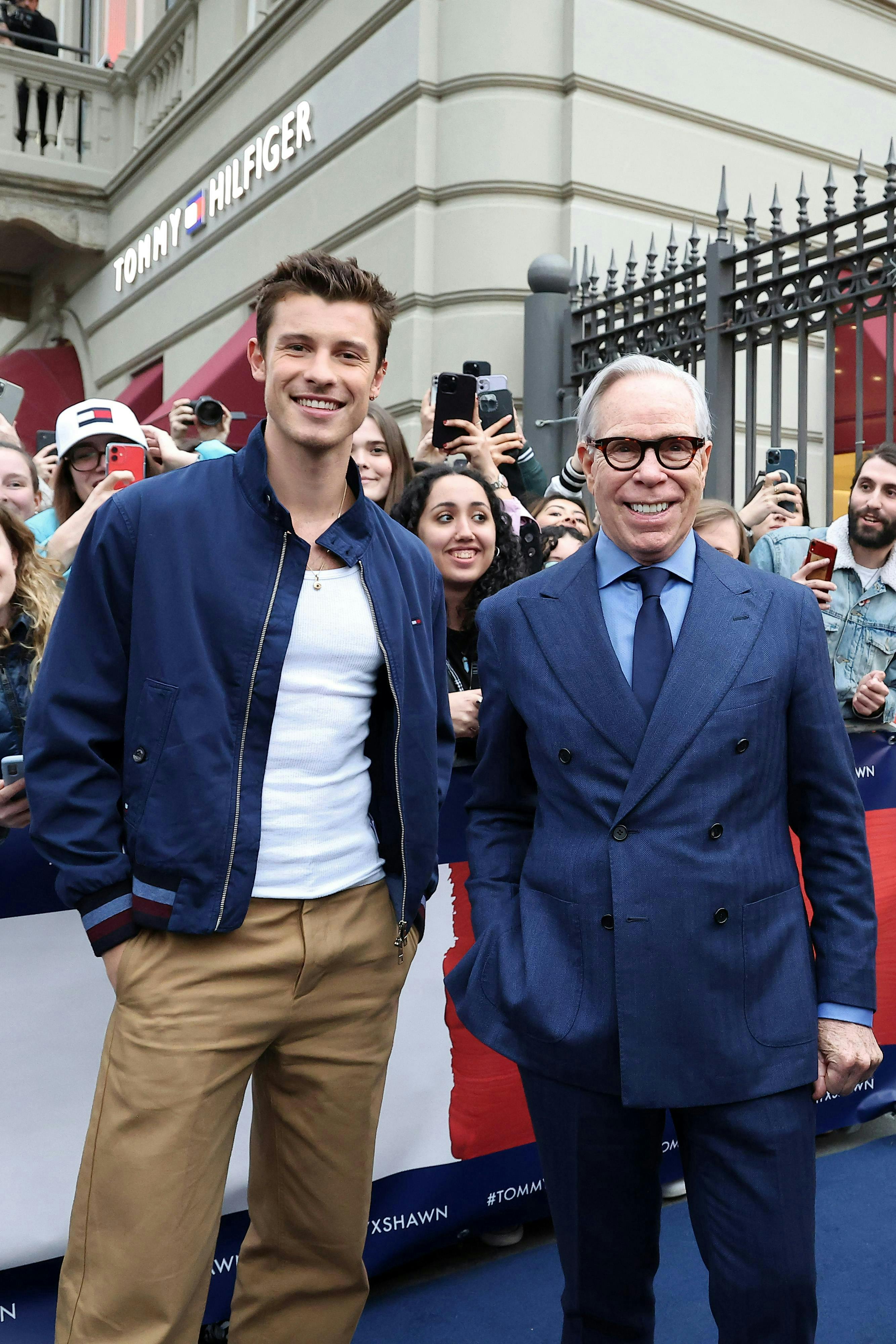 arts culture and entertainment celebrities tommy hilfiger - designer label milan fashion glasses adult male man person mobile phone female woman coat