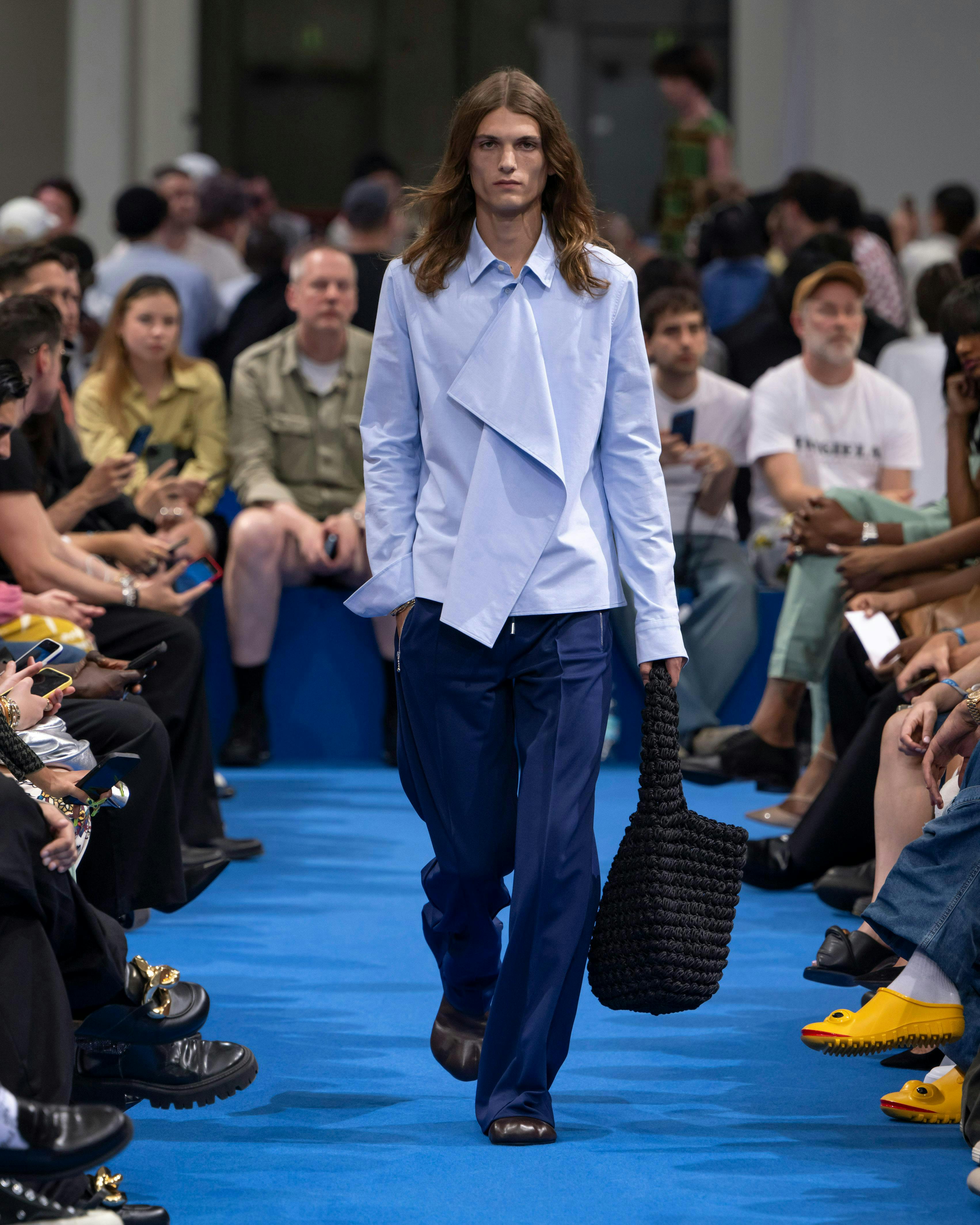 handbag fashion shoe person pants adult male man mobile phone coat
