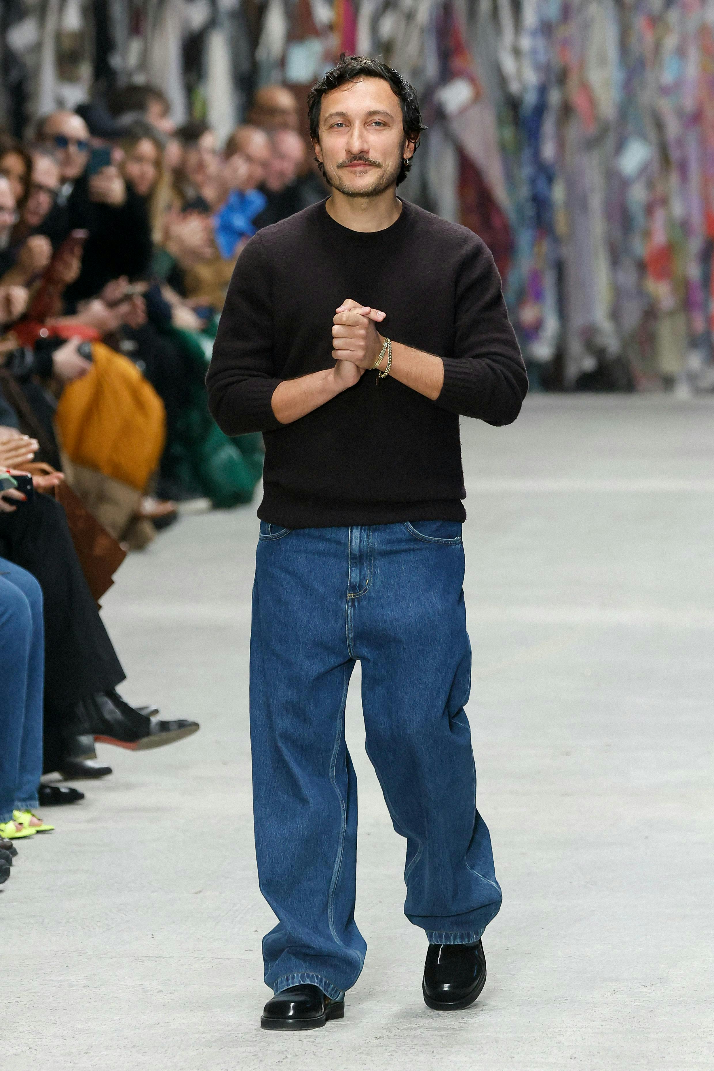 pants jeans adult male man person fashion standing sweater handbag