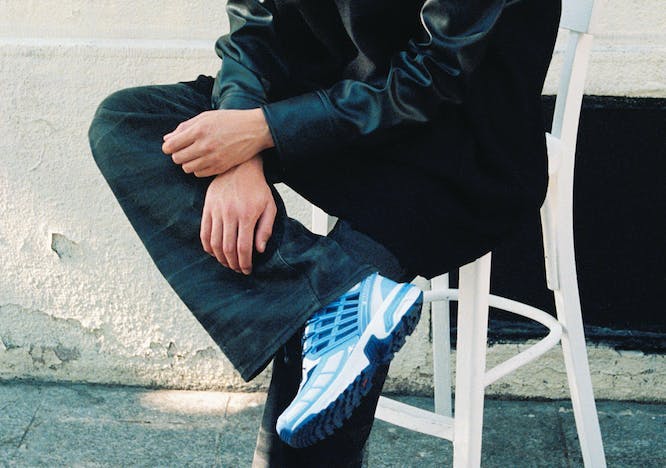 pants shoe person sitting coat sneaker boy male teen jeans