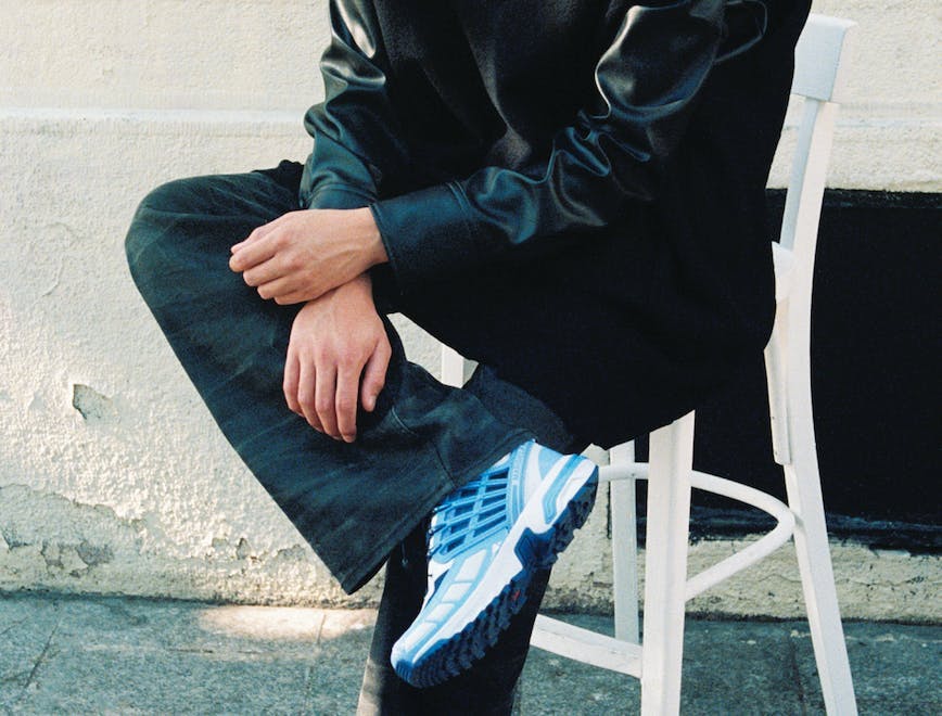 pants shoe person sitting coat sneaker boy male teen jeans